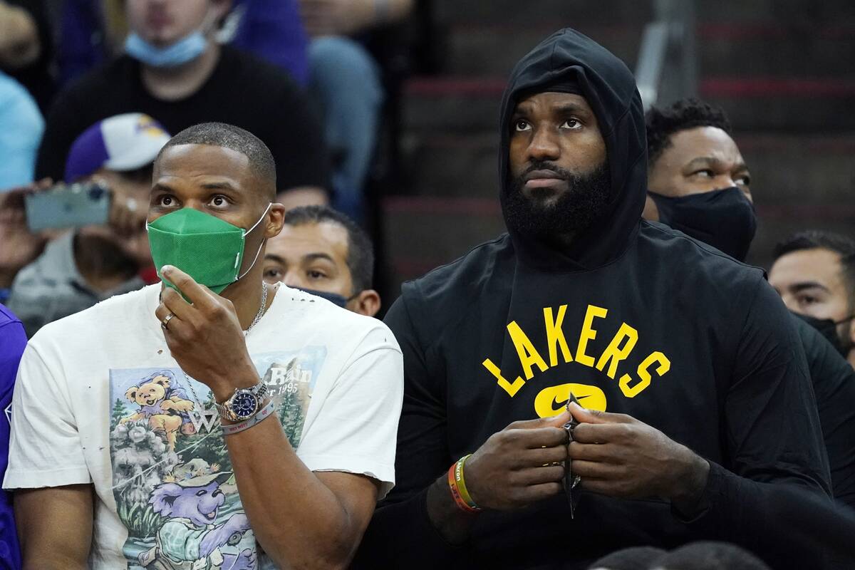 Los Angeles Lakers' LeBron James, right, and Russell Westbrook watch their teammates during the ...