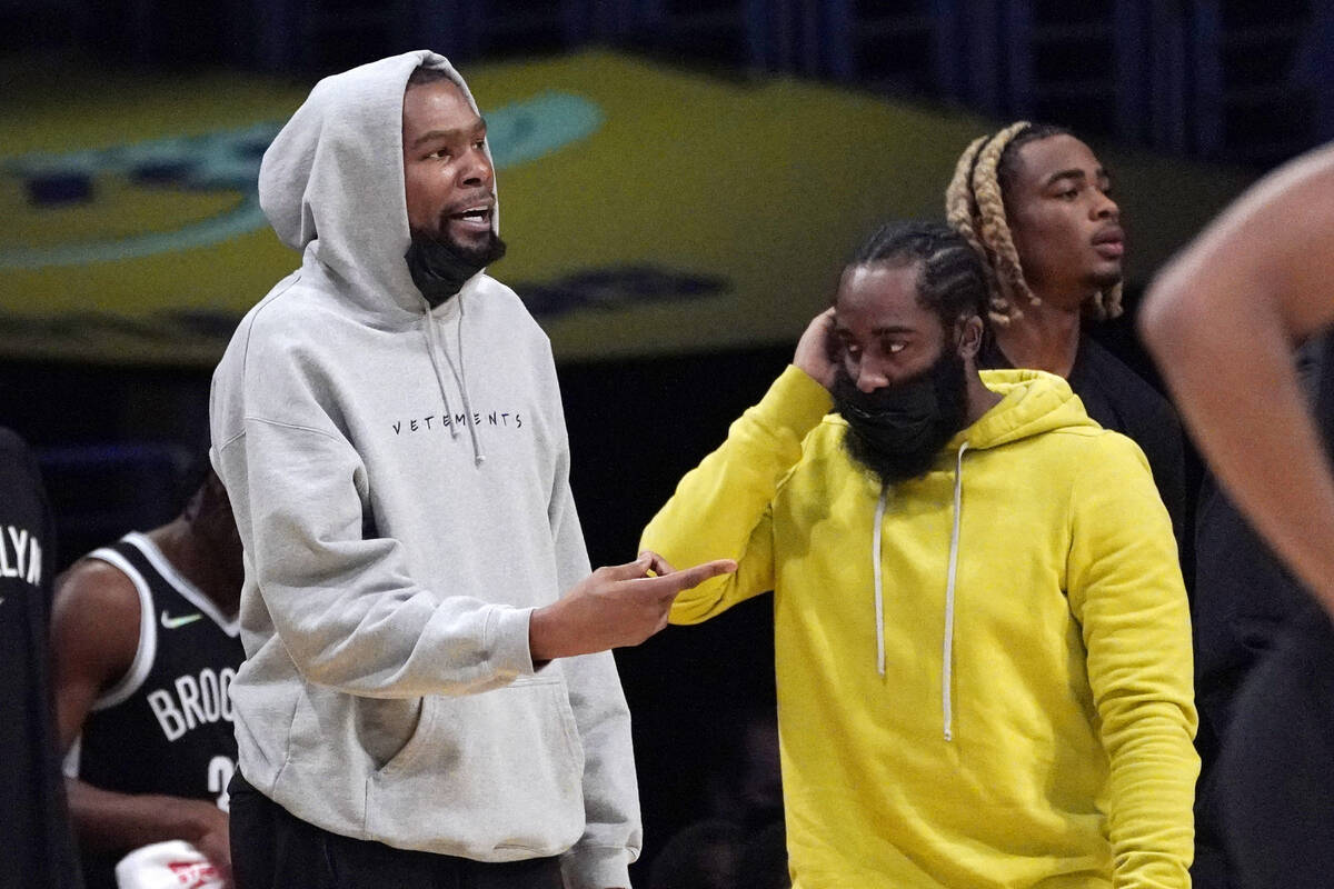 Brooklyn Nets forward Kevin Durant, left, and guard James Harden stand near the bench during th ...