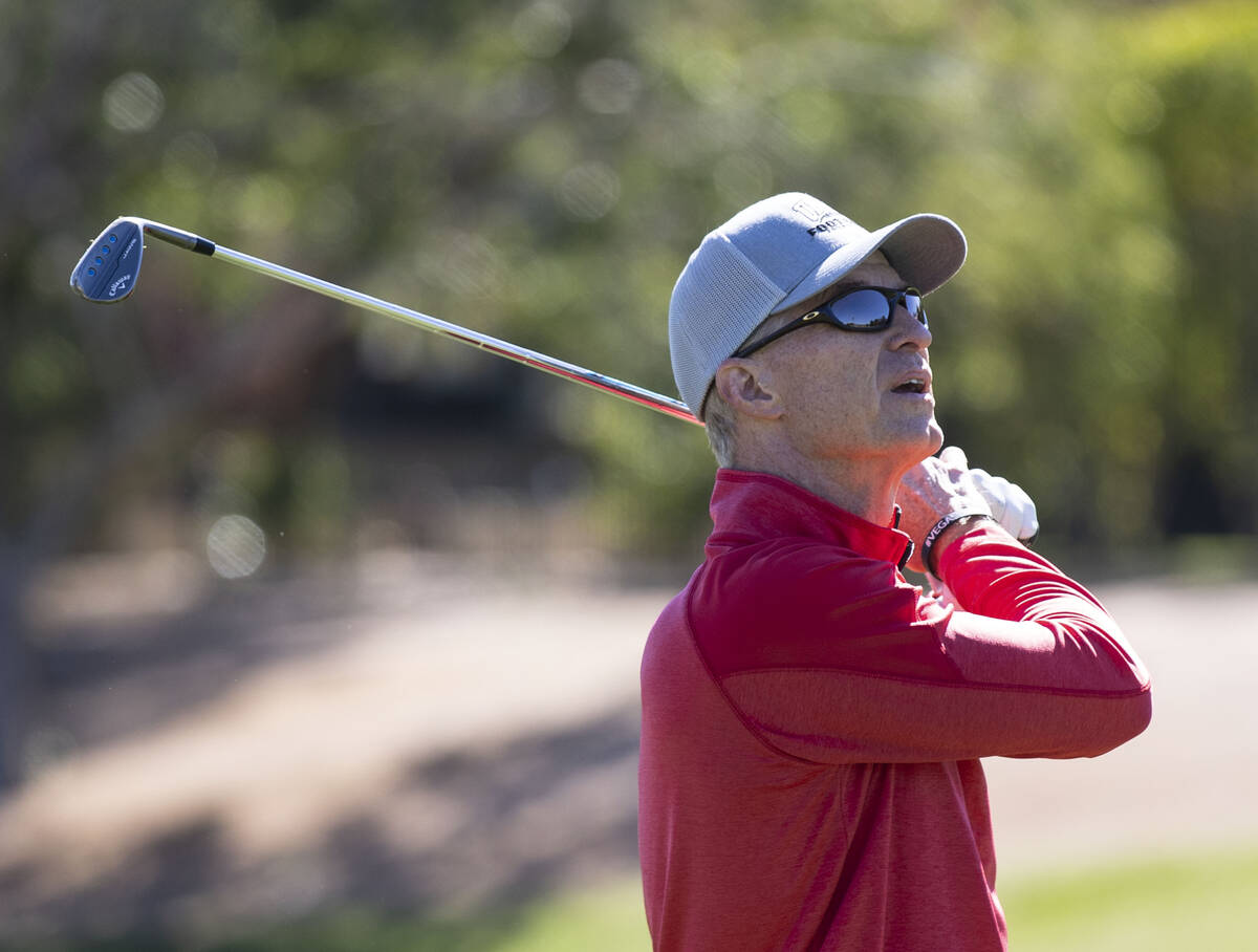 Former UNLV starting quarterback Steve Stallworth watches his drive during Canyon Springs golf ...
