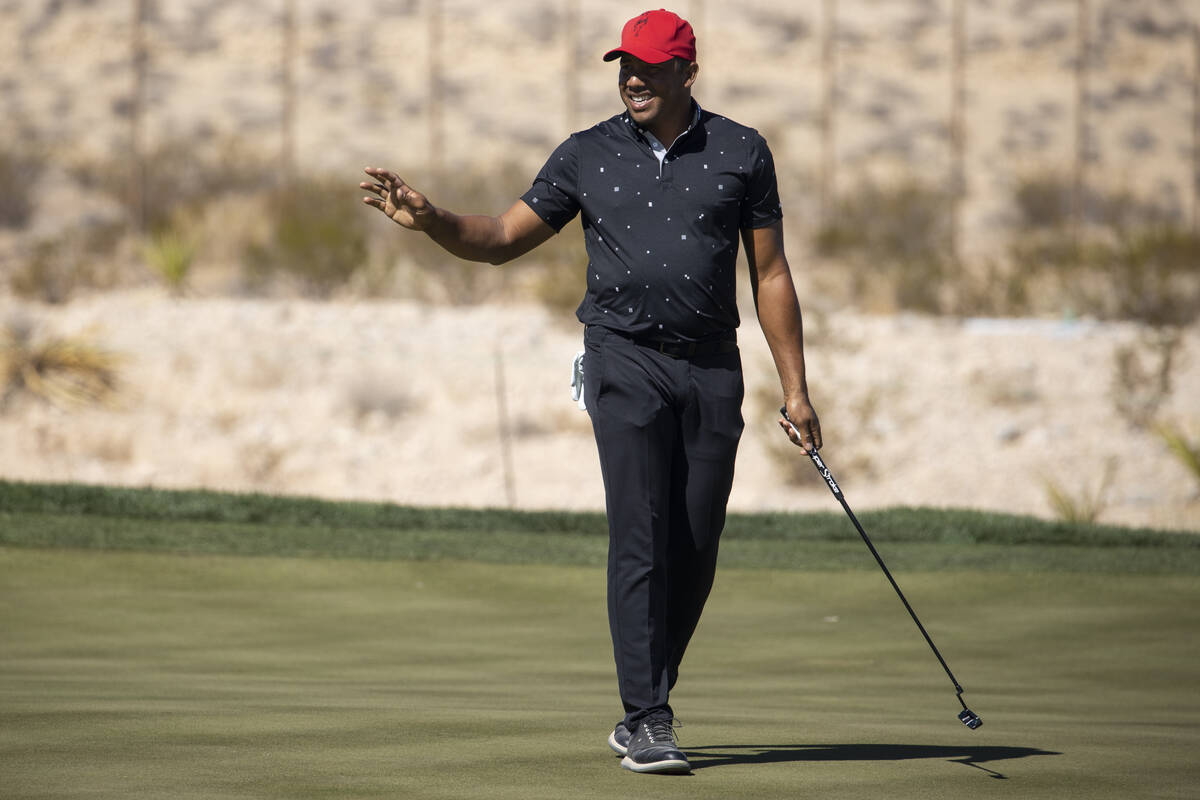 Jhonattan Vegas raises his hand after hitting a putt for a birdie in the 18th green to complete ...