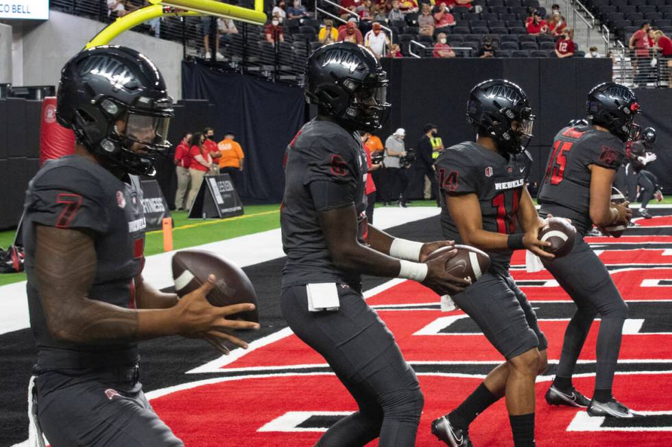 UNLV Rebel's quarterbacks Cameron Friel (7) Justin Rogers (5) Jared Heywood (14) and Matthew Ge ...