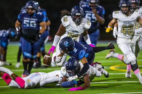 Canyon SpringsÕ Lackawanna Caston (12) fumbles the ball after a hard hit by FoothillÕs Amario ...