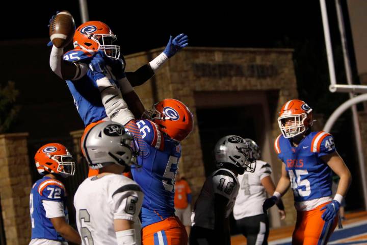 Bishop Gorman High School's William Stallings (25), top, celebrates his touchdown with Zak Yama ...