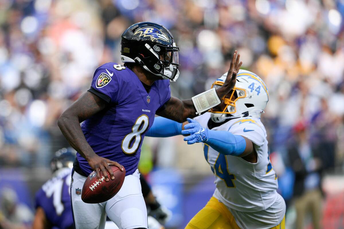Los Angeles Chargers outside linebacker Kyzir White rushes in on Baltimore Ravens quarterback L ...