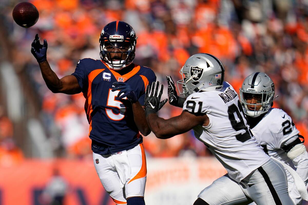Denver Broncos quarterback Teddy Bridgewater (5) is pressured by Las Vegas Raiders defensive en ...