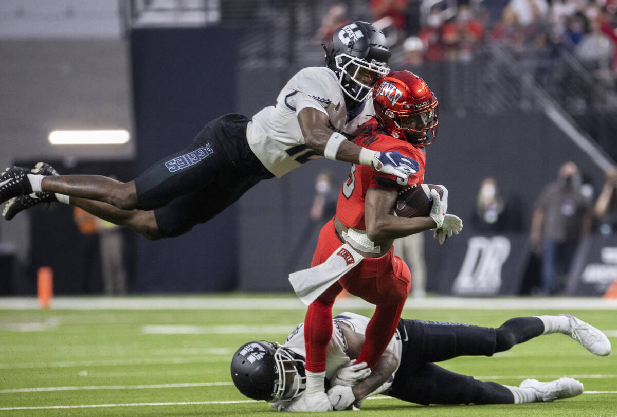 UNLV Rebels wide receiver Zyell Griffin (3) makes a big catch and run past Utah State Aggies sa ...