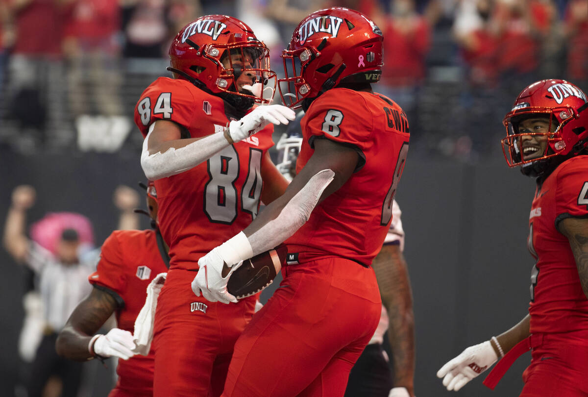 UNLV Rebels running back Charles Williams (8) celebrates a first half touchdown run with UNLV R ...