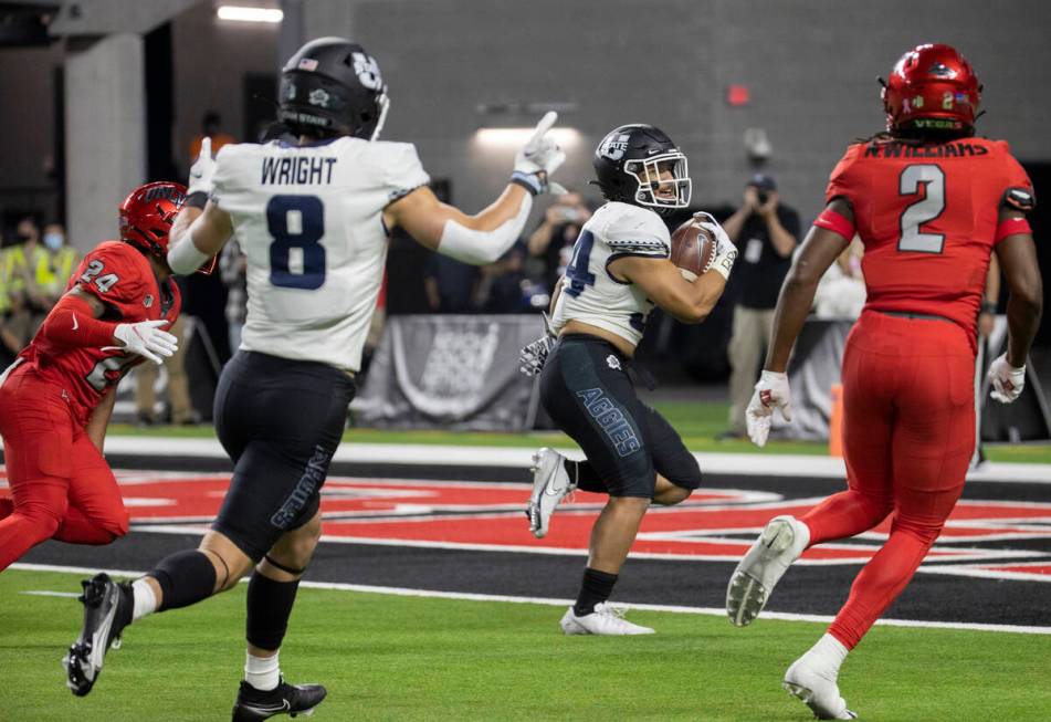 Utah State Aggies running back Elelyon Noa (34) scores the go ahead touchdown past UNLV Rebels ...