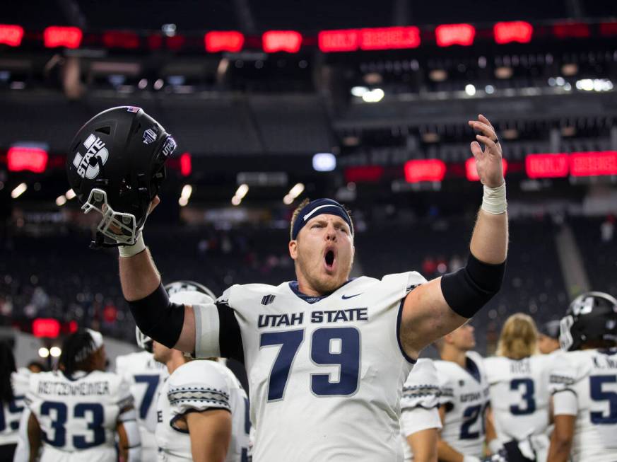 Utah State Aggies offensive lineman Wade Meacham (79) celebrates after beating UNLV at the end ...