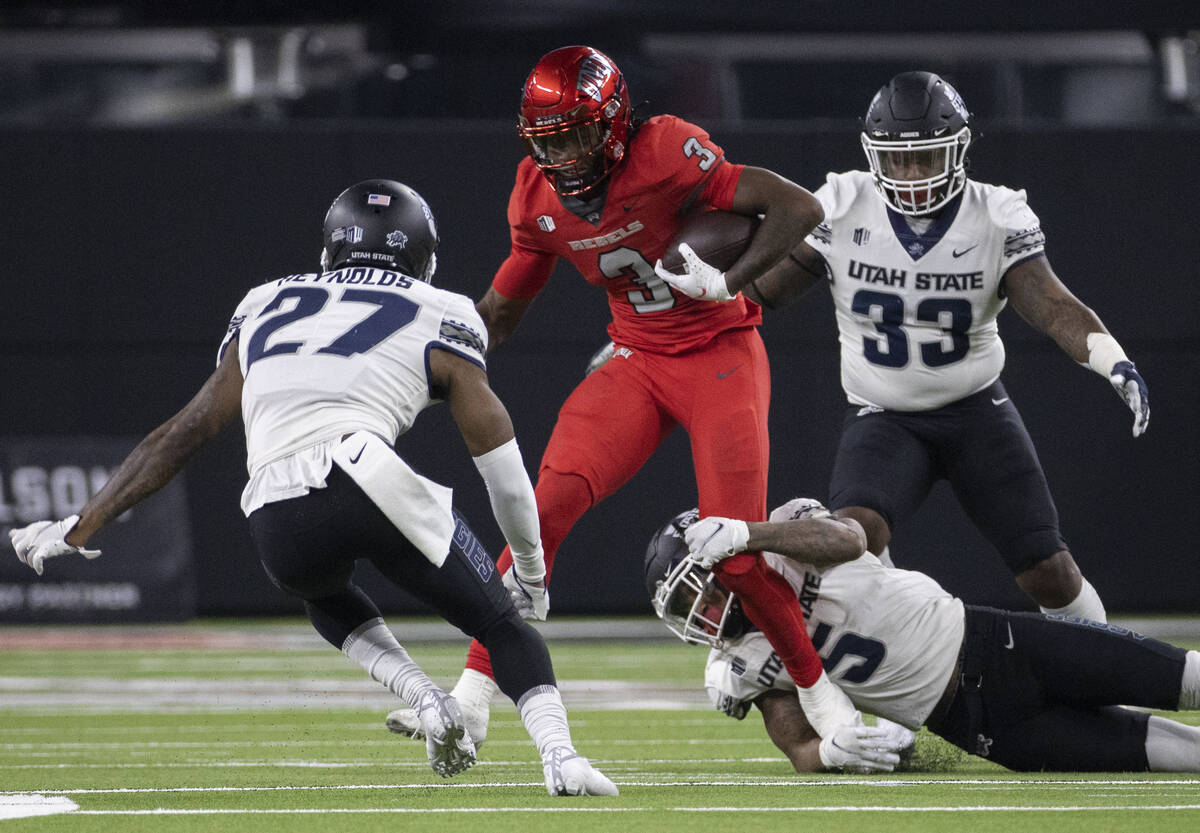 UNLV Rebels wide receiver Zyell Griffin (3) makes a catch and run with Utah State Aggies lineba ...