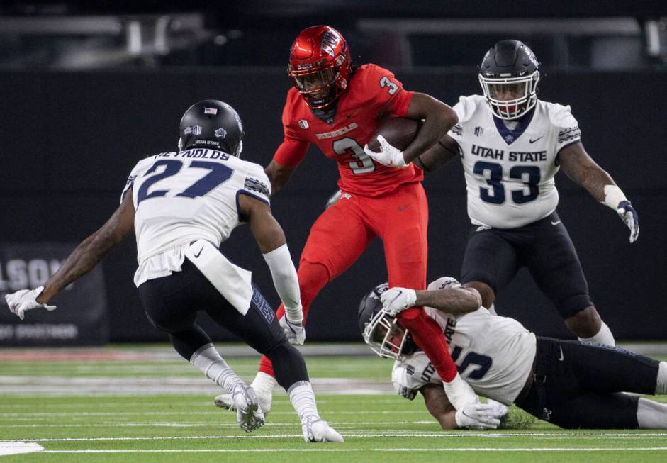 UNLV Rebels wide receiver Zyell Griffin (3) makes a catch and run with Utah State Aggies lineba ...