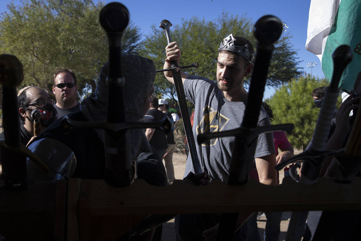 Jakob Knopp, of Las Vegas, tests out a potential sword with his friend Dillon McNamara during t ...