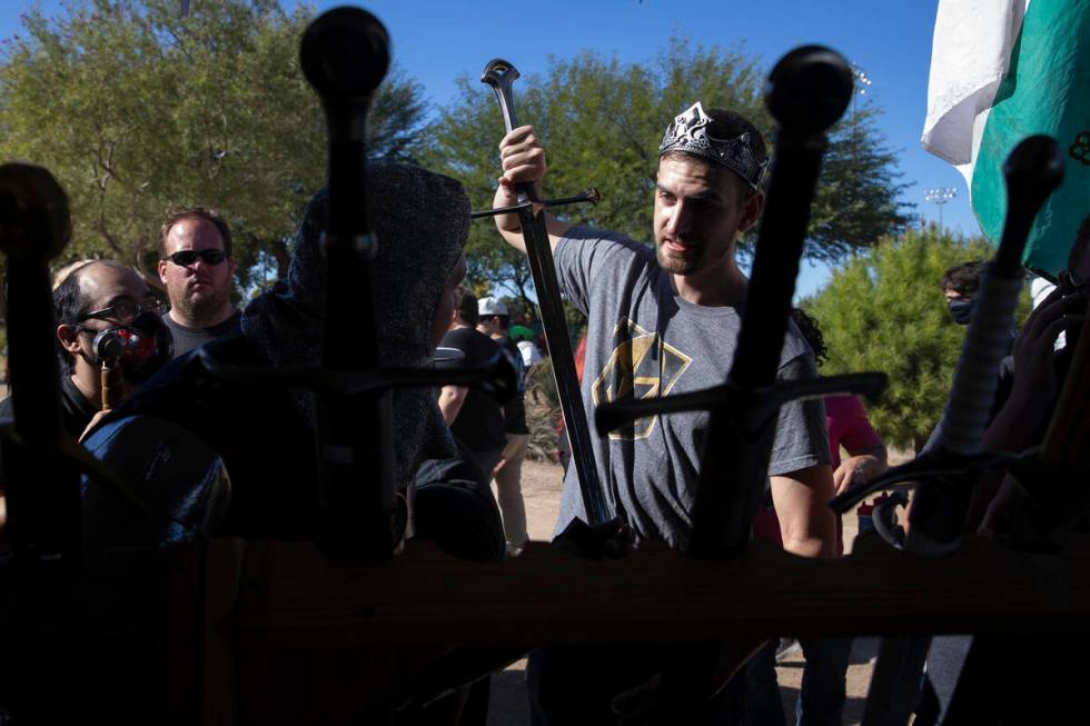 Jakob Knopp, of Las Vegas, tests out a potential sword with his friend Dillon McNamara during t ...