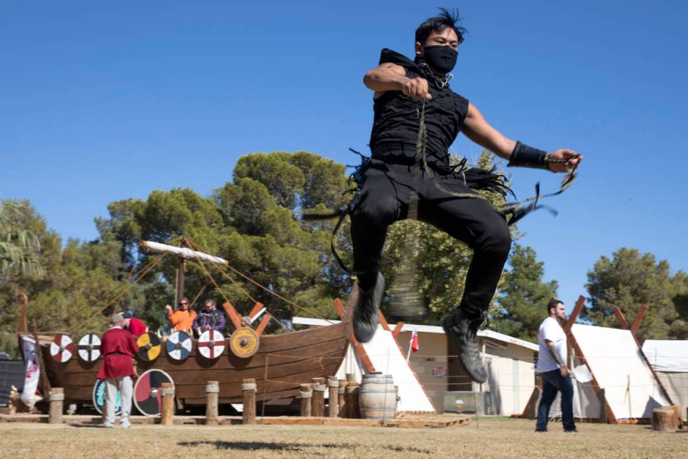 Kai Aquino practices flow arts with a rope dart during the Age of Chivalry Renaissance Festival ...