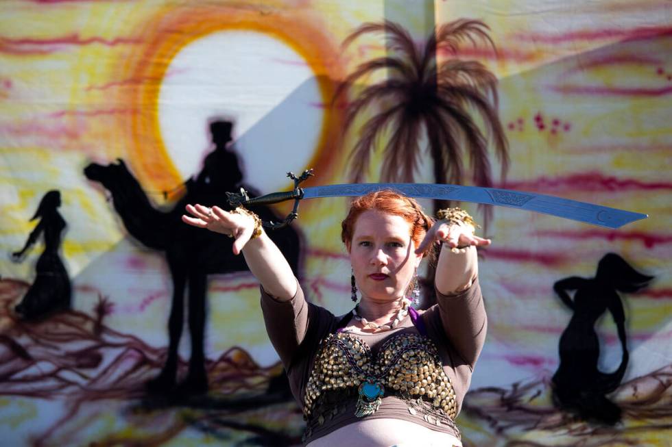 Kelley Blatnik, who owns a Las Vegas law firm, balances a sword on her head for an audience dur ...