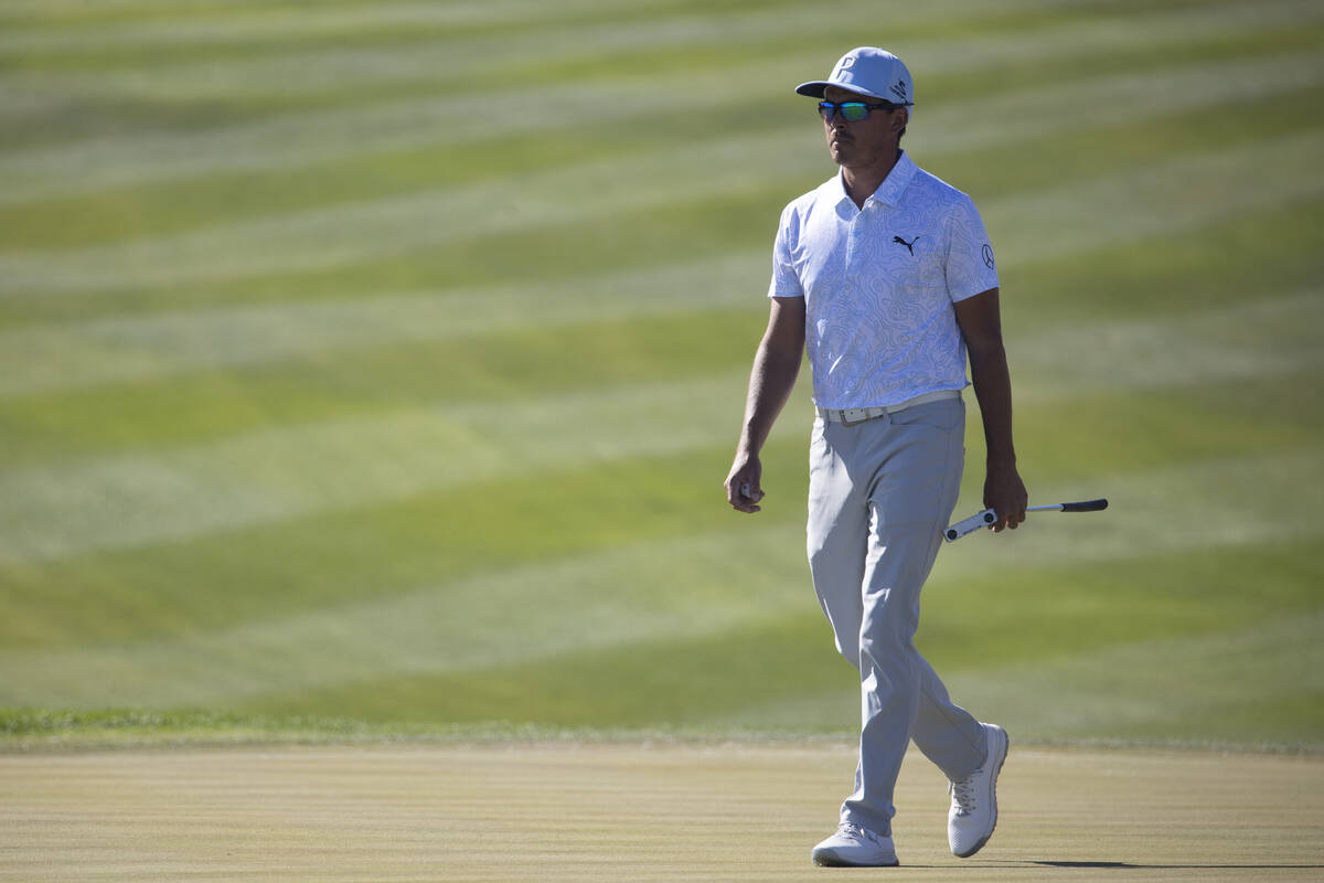 Rickie Fowler walks on the 11th green after finishing the hole box during the third round of th ...