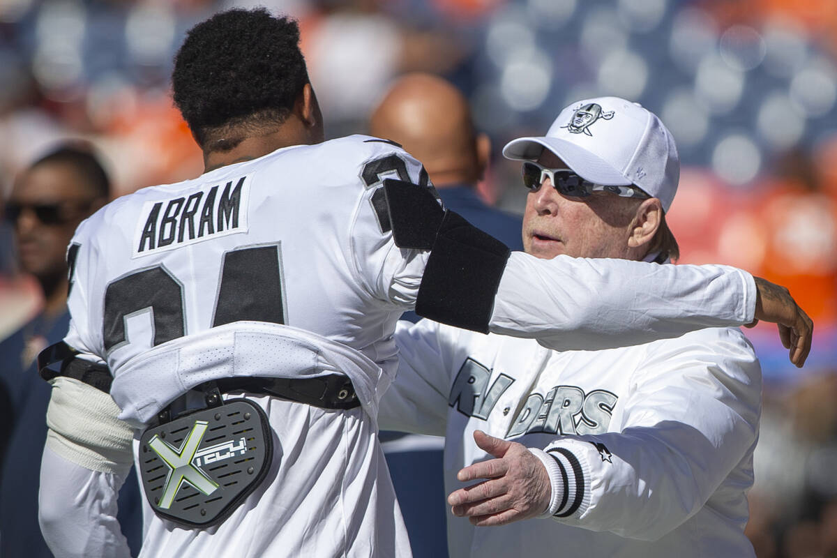 Raiders safety Johnathan Abram (24) hugs team owner Mark Davis before an NFL football game agai ...