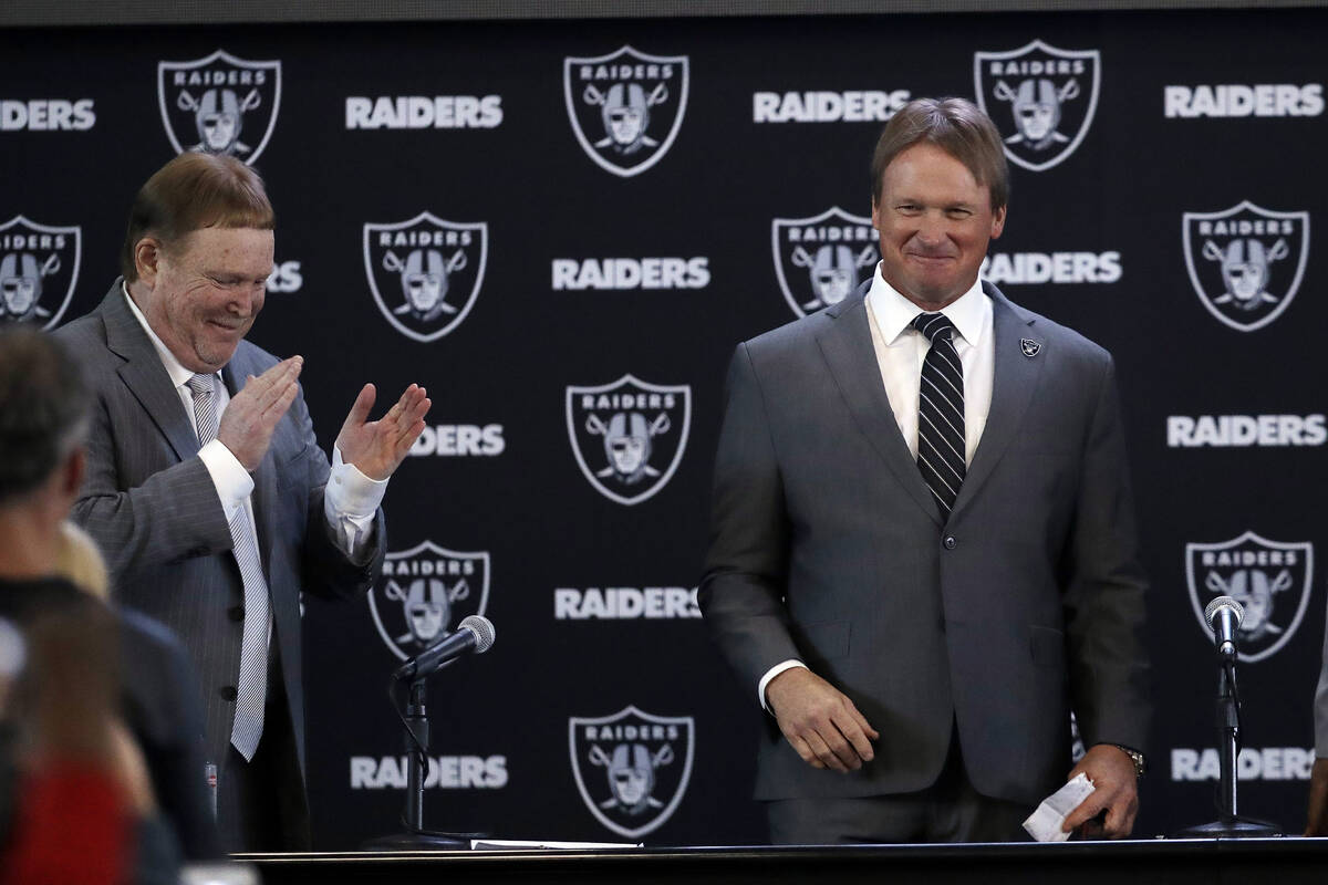 Oakland Raiders head coach Jon Gruden, right, smiles next to owner Mark Davis after an NFL foot ...