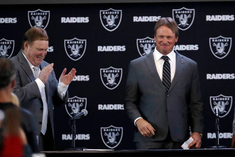 Oakland Raiders head coach Jon Gruden, right, smiles next to owner Mark Davis after an NFL foot ...