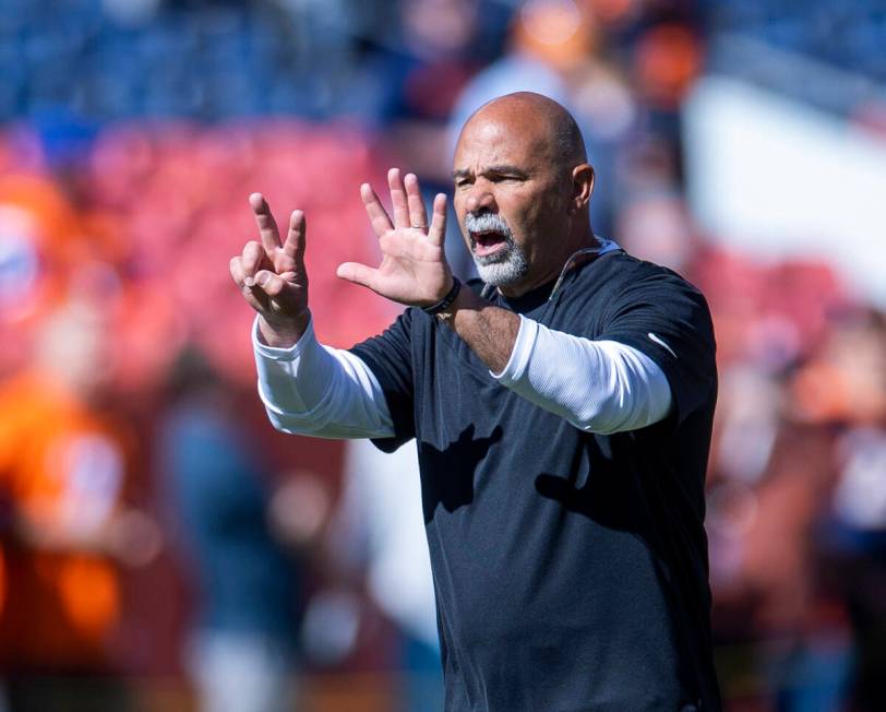 Raiders interim head coach Rich Bisaccia signals a player before the first half of an NFL game ...