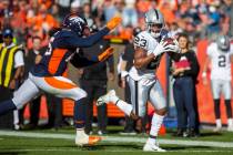 Raiders running back Kenyan Drake (23) runs past Denver Broncos inside linebacker A.J. Johnson ...