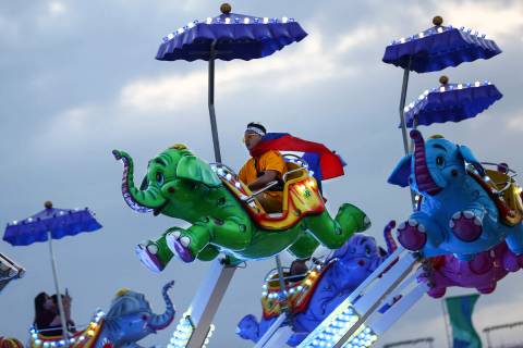 Phouvanh Sengchanh, of Anaheim, Calif., enjoys a carnival ride during the second day of the Ele ...