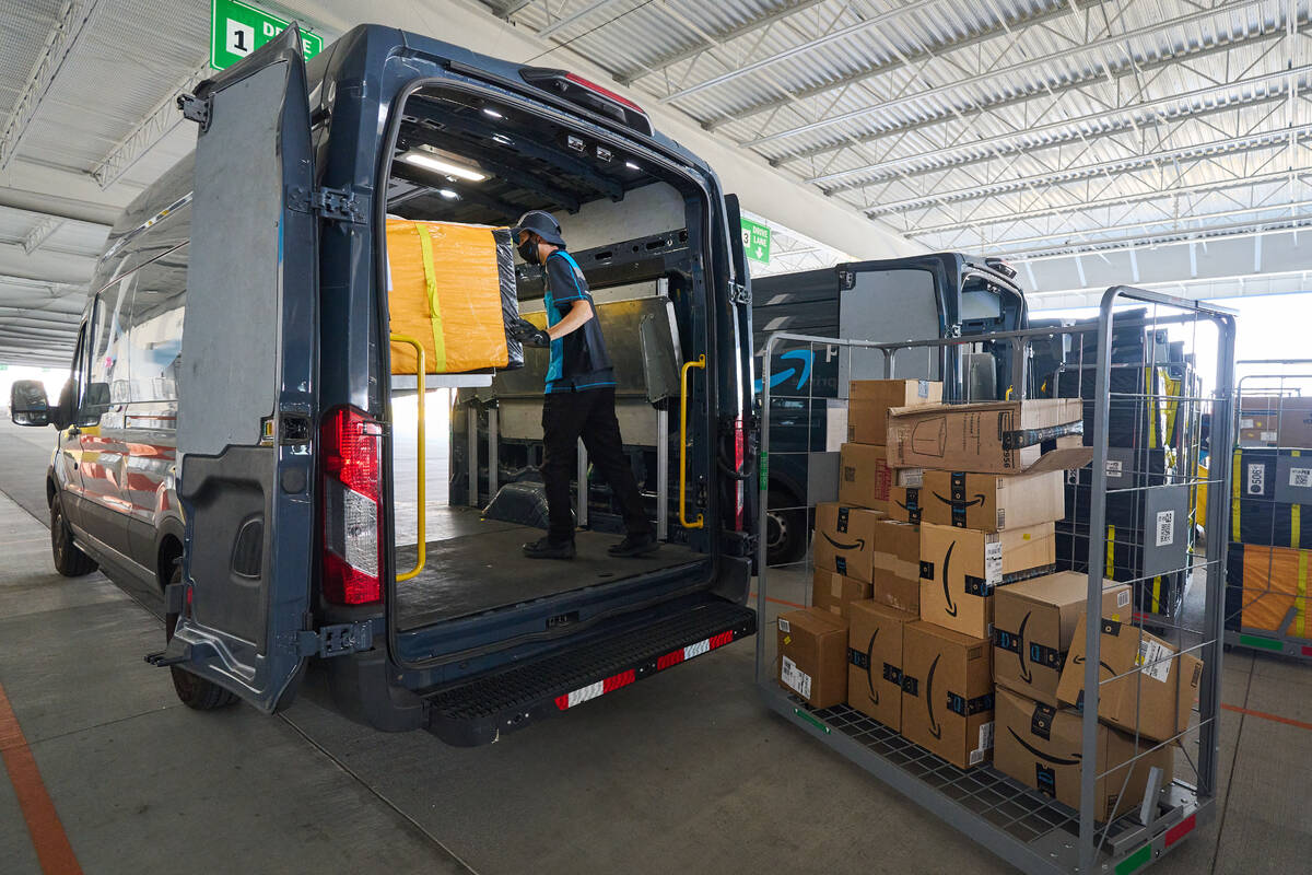 A worker loads an Amazon delivery van. The company recently opened its latest Las Vegas area di ...