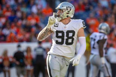 Raiders defensive end Maxx Crosby (98) gestures to silence the crowd after sacking Denver Bronc ...