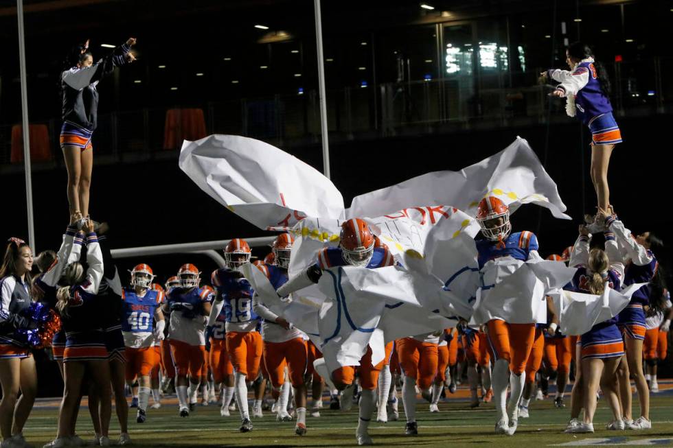 Bishop Gorman High School's players run out to the field before the second half of a football g ...