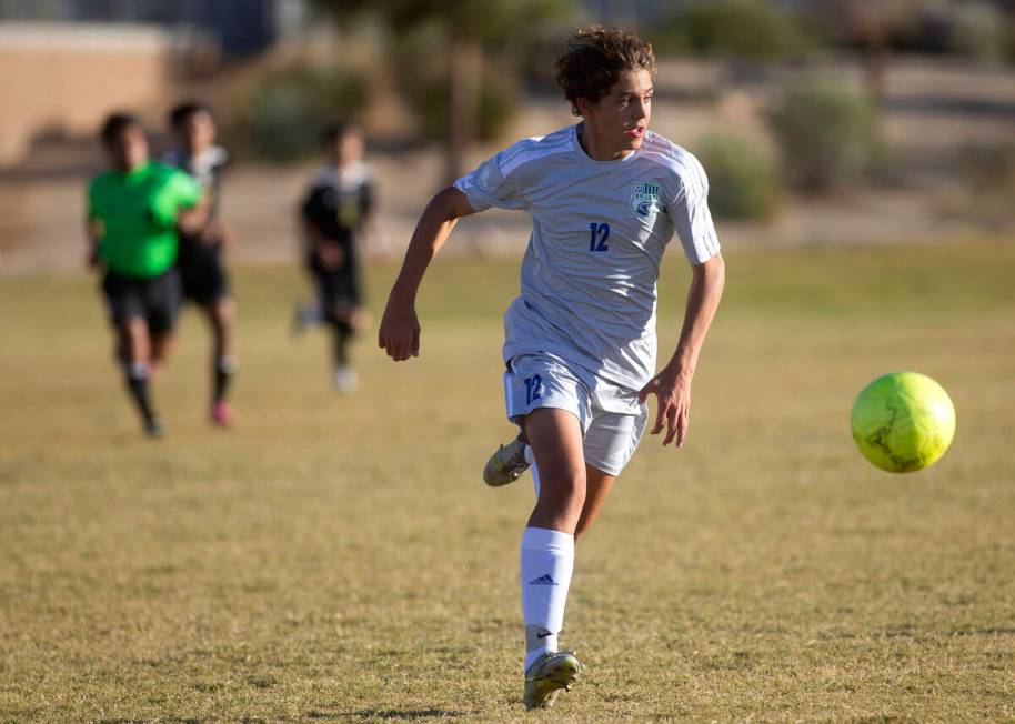 Green Valley's Kevin Kucik (12) dribbles up the field during a boys high school soccer game aga ...