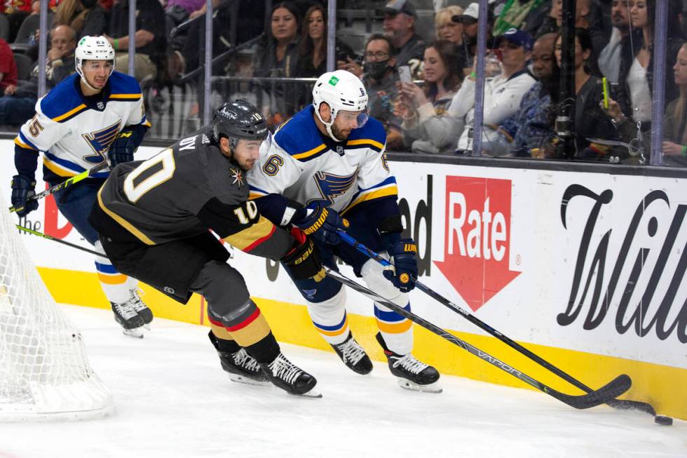 Golden Knights center Nicolas Roy (10) and Blues defenseman Marco Scandella (6) skate for the p ...