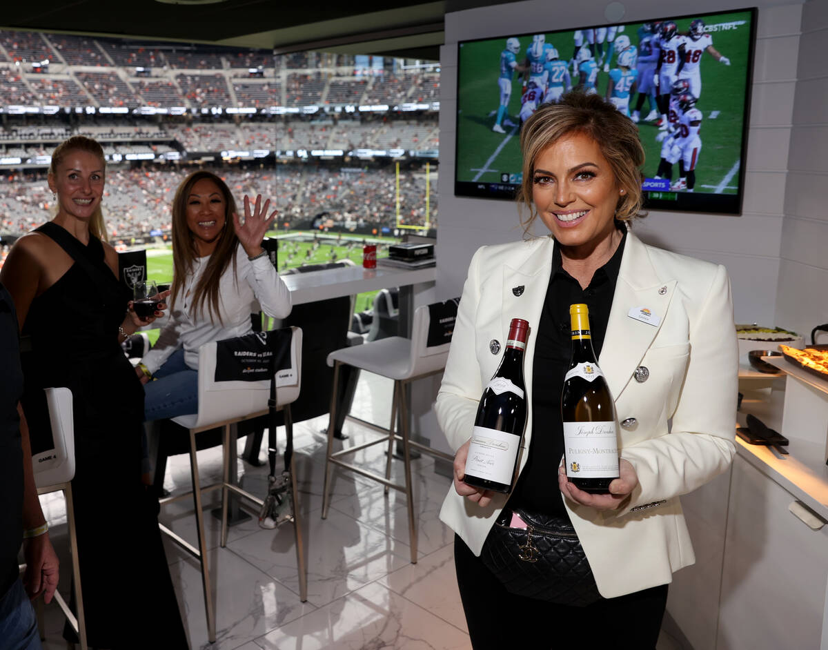 Sandra Taylor, head sommelier at Allegiant Stadium in Las Vegas, right, shows some of her wine ...