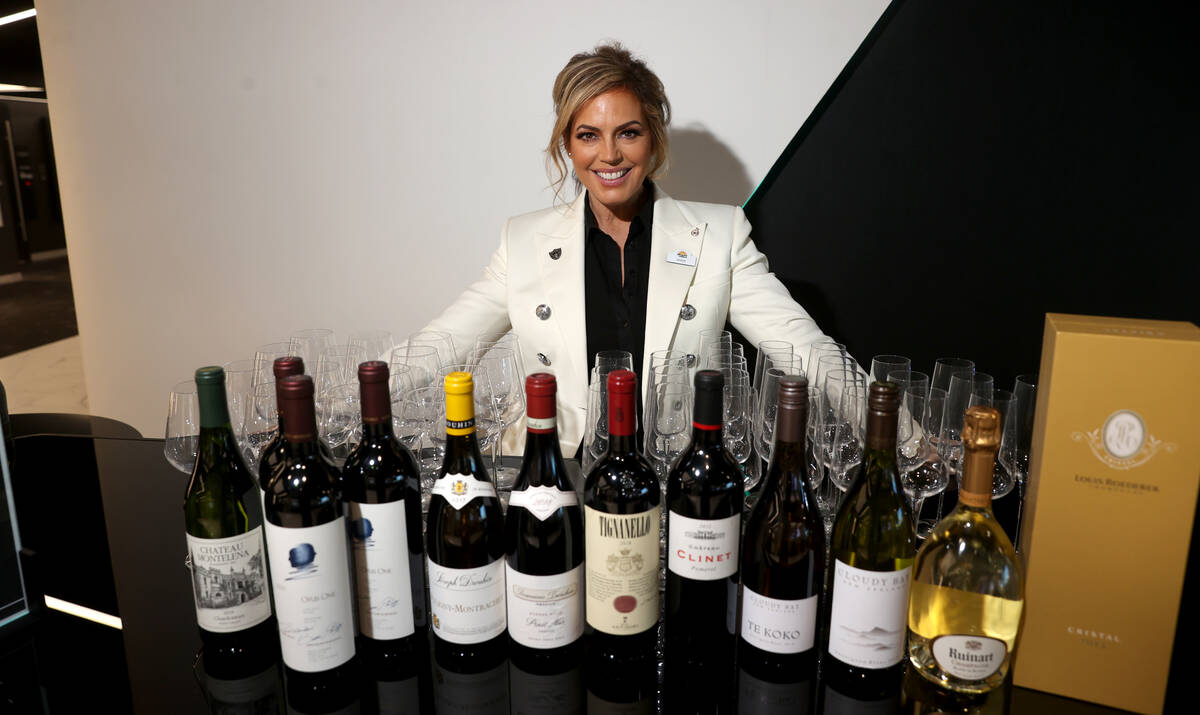 Sandra Taylor, head sommelier at Allegiant Stadium in Las Vegas, right, shows some of her wine ...