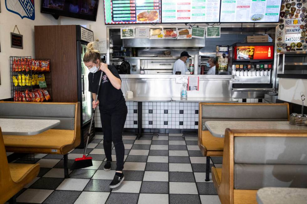 Cashier Bryte Kiser sweeps the floor at Broadway Pizza in Las Vegas, Thursday, Oct. 21, 2021. ( ...