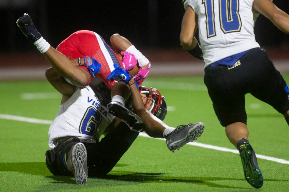 Coronado's Jaylen Garrison (10) is tackled by Sierra Vista's Akela Kahaleanu (6) during a high ...