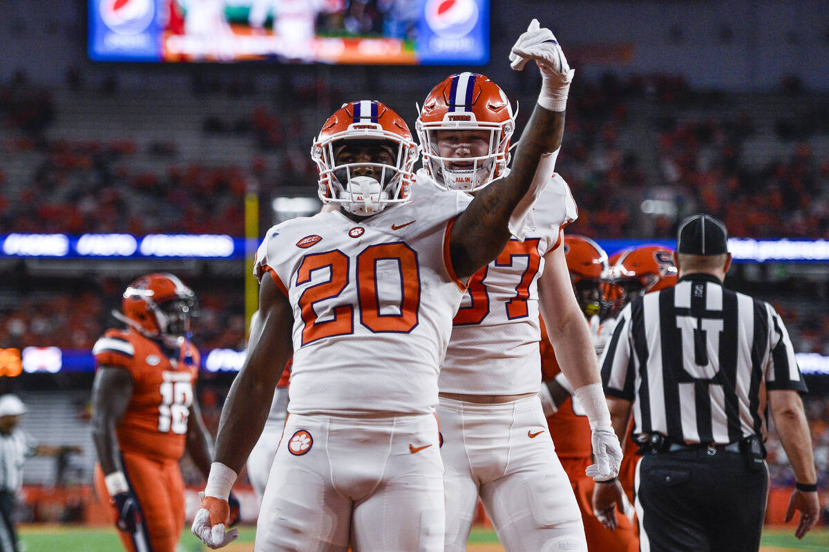 Clemson running back Kobe Pace (20) celebrates with tight end Sage Ennis (87) after scoring a t ...