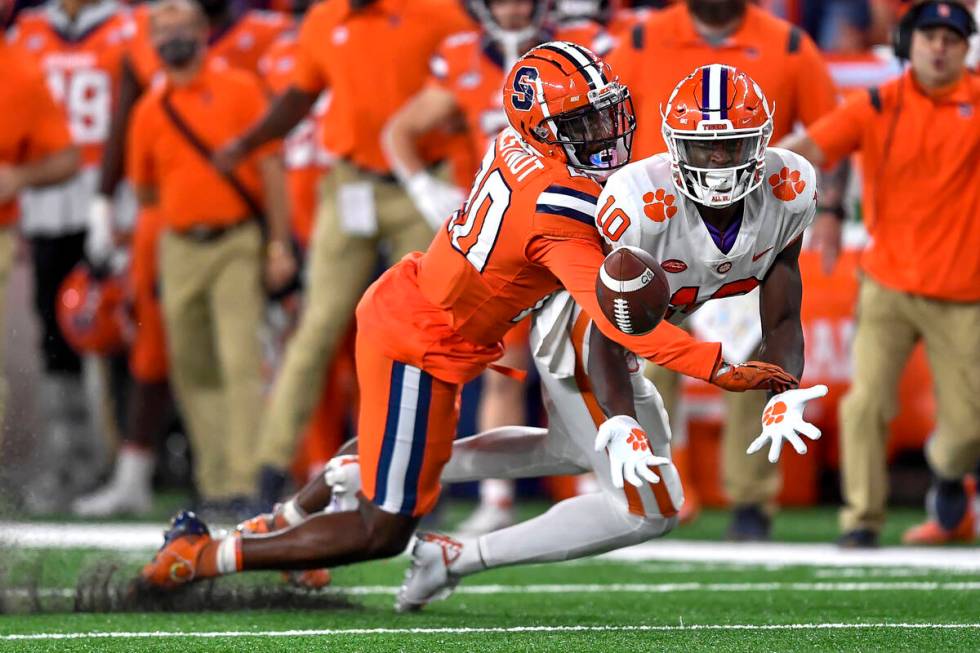 Syracuse defensive back Darian Chestnut, left, breaks up a pass intended for Clemson wide recei ...