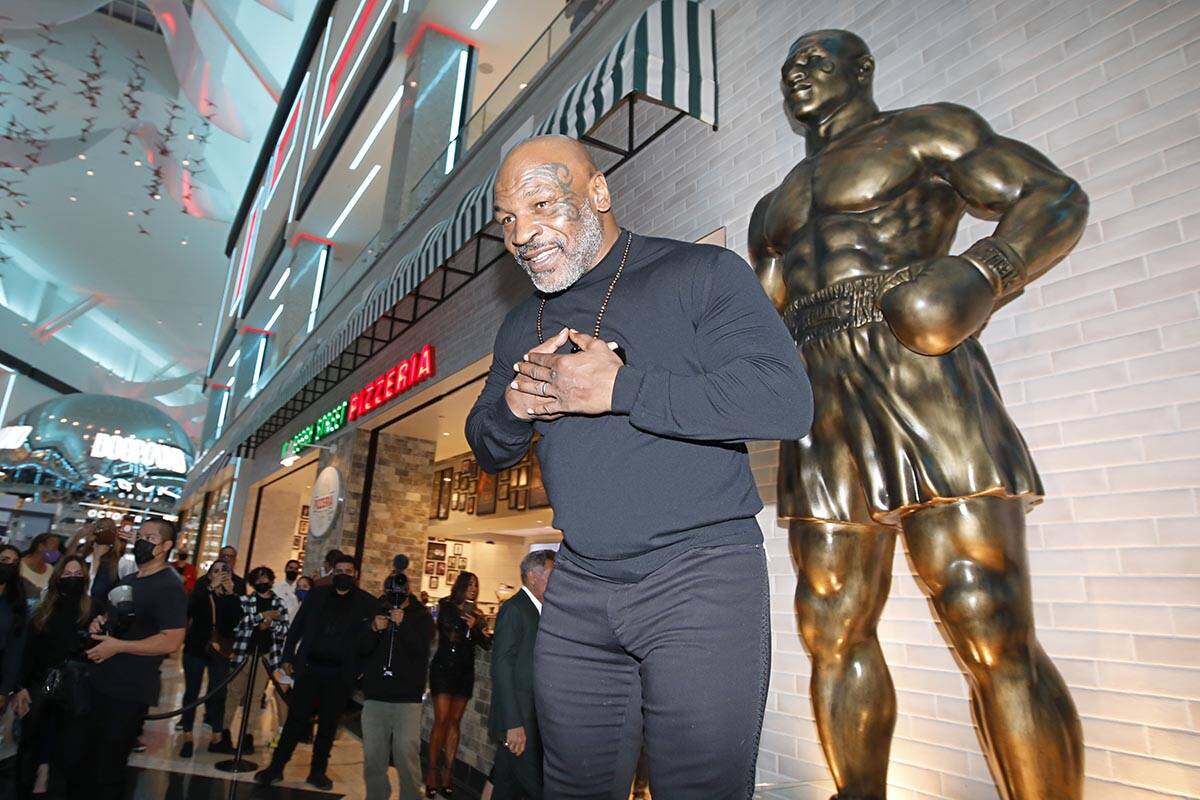 Former boxer Mike Tyson greets people in front of his newly unveiled statue at Mulberry Street ...