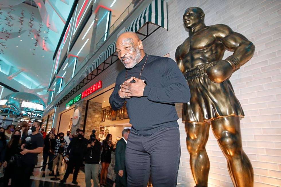 Former boxer Mike Tyson greets people in front of his newly unveiled statue at Mulberry Street ...