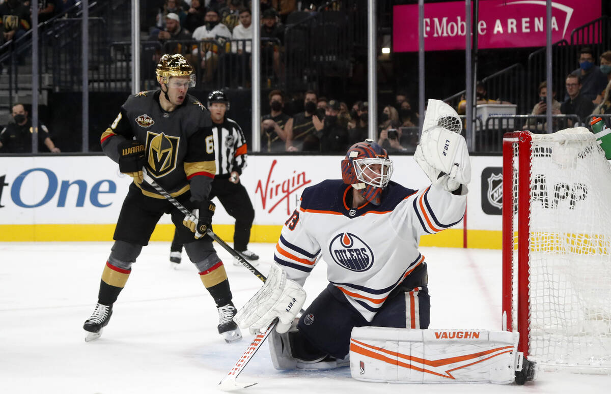 Edmonton Oilers goaltender Mikko Koskinen (19) makes a glove-save as Vegas Golden Knights right ...