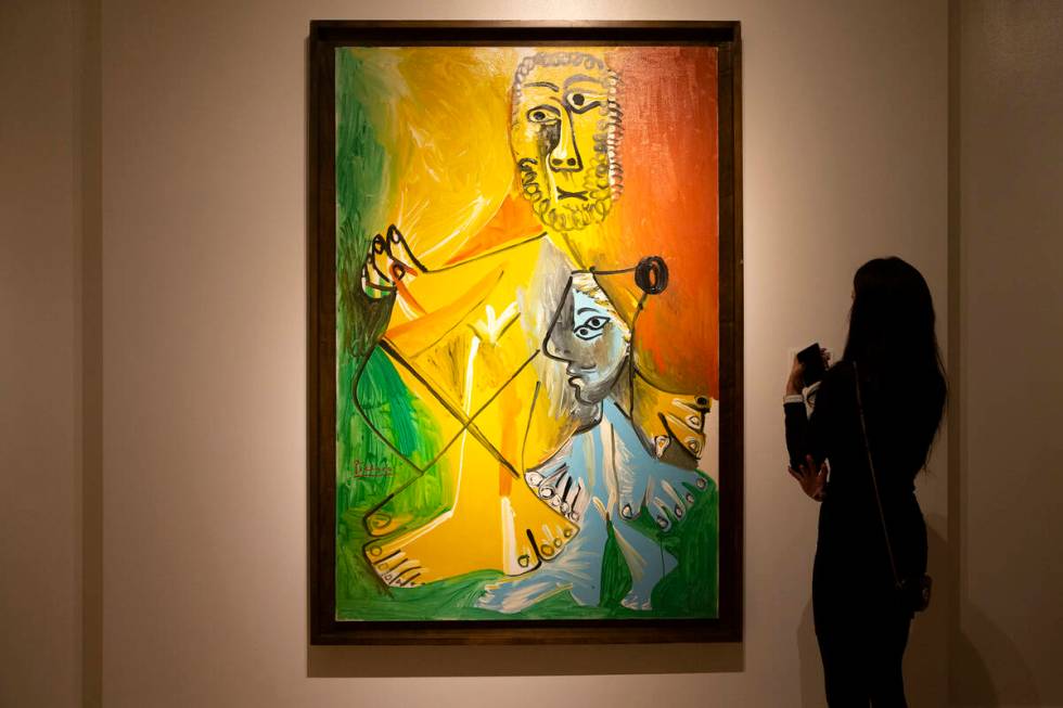 A visitor views Pablo Picasso's "Homme et enfant" at the Bellagio Gallery of Fine Art on Friday ...