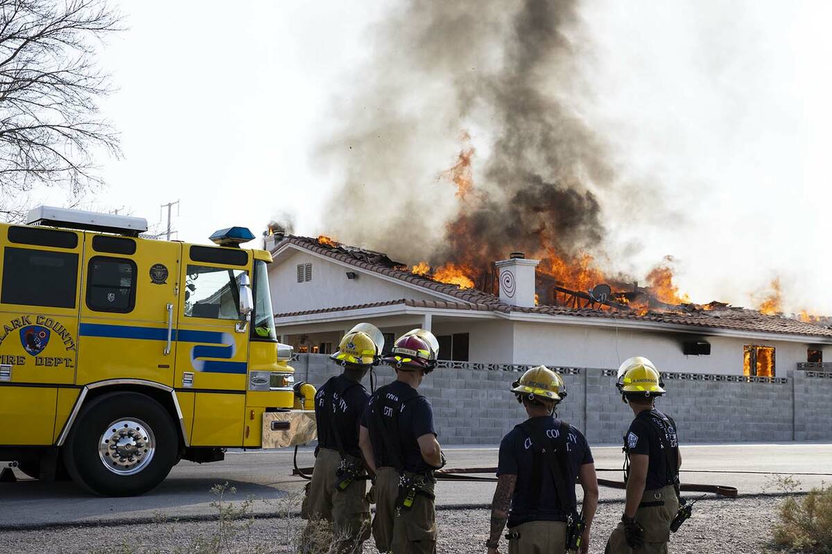 The Clark County firefighters watch a controlled burn of a house at Schuster St, on Friday, Sep ...