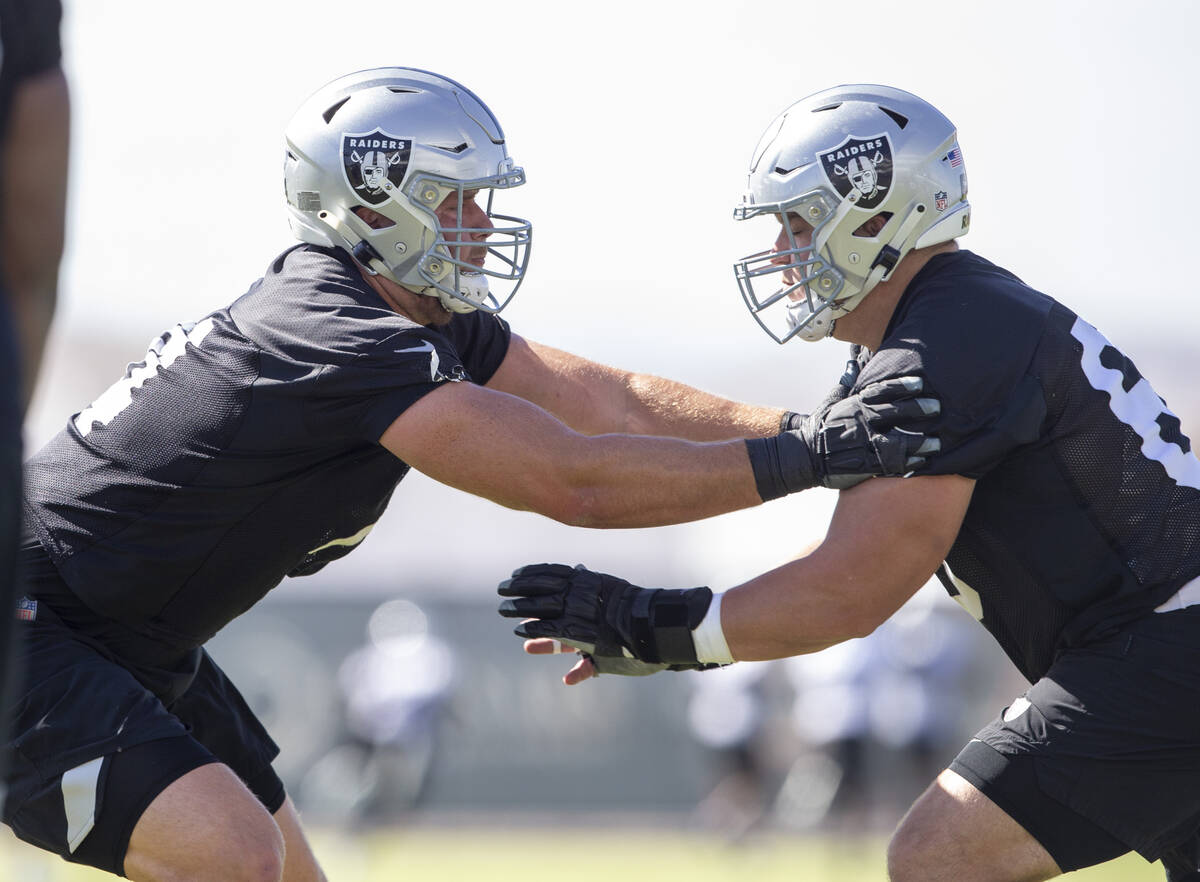 Raiders offensive tackle Kolton Miller (74), left, works against Raiders center Nick Martin (66 ...