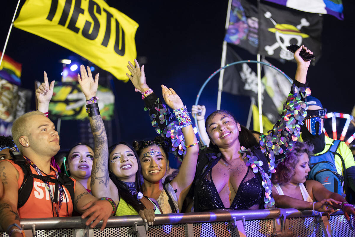People dance as Kaskade performs at the Kinetic Field stage during the final day of the Electri ...