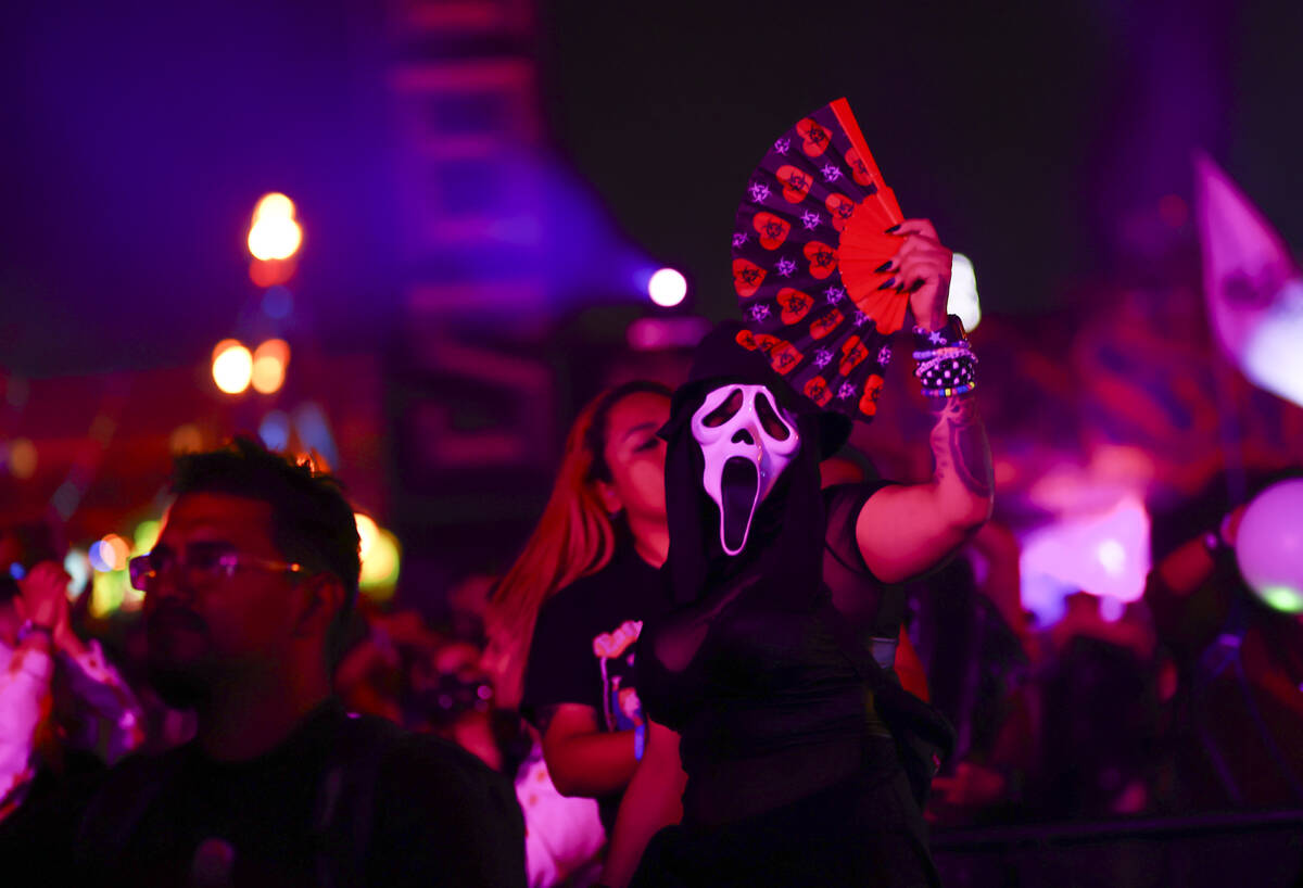 An attendee wearing a mask dances during the final day of the Electric Daisy Carnival at the La ...
