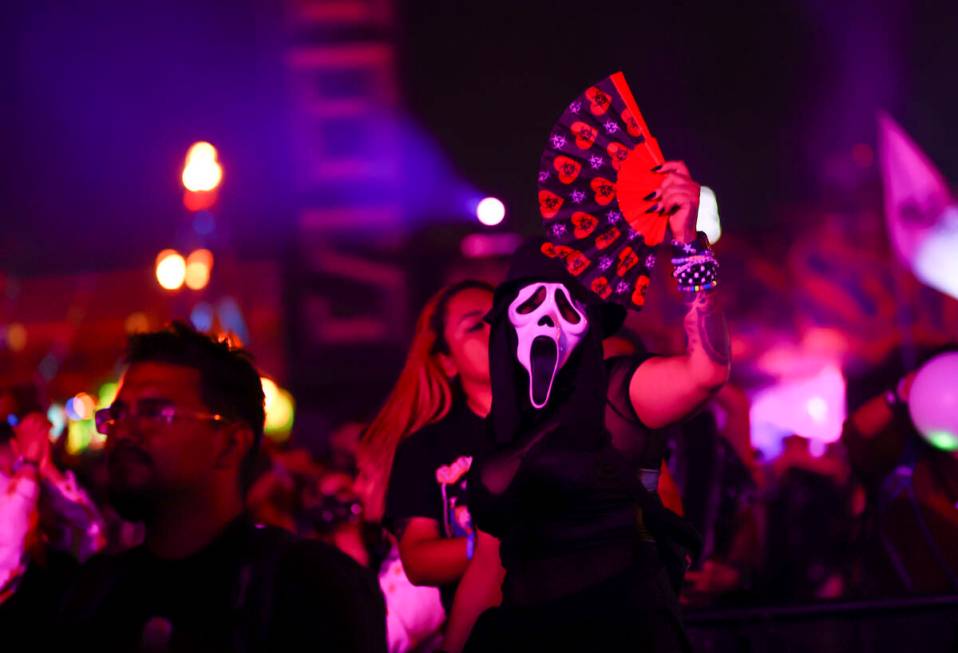 An attendee wearing a mask dances during the final day of the Electric Daisy Carnival at the La ...
