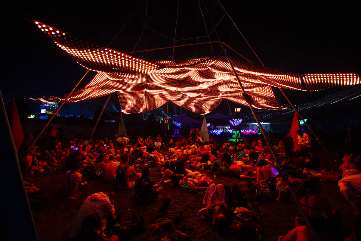 Attendees relax beneath an art installation during the Electric Daisy Carnival at the Las Vegas ...