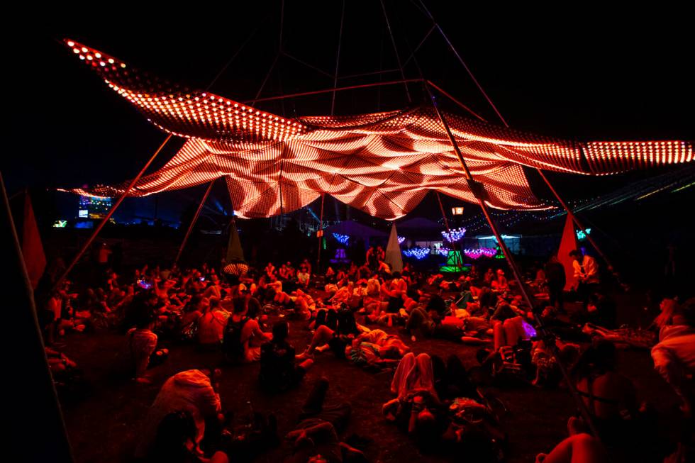 Attendees relax beneath an art installation during the Electric Daisy Carnival at the Las Vegas ...