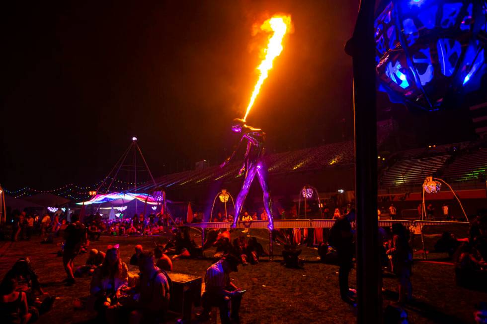 Attendees hang out around a pyrotechnic sculpture during the Electric Daisy Carnival at the Las ...