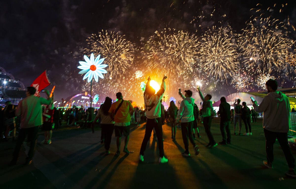 Attendees react as fireworks go off during the second day of the Electric Daisy Carnival at the ...